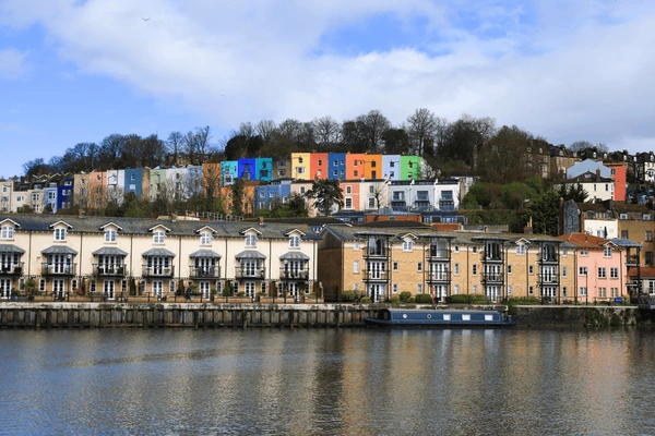 Rows of brightly painted houses on the hillside above Bristol's floating harbour